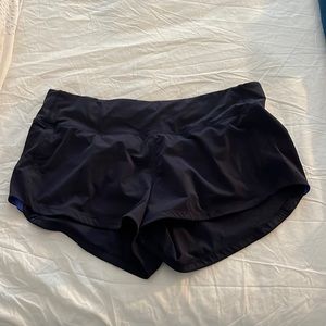 Navy blue shot Lululemon running shorts with brighter blue detailing on sides